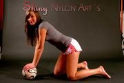 Alina wearing sexy white shiny nylon shorts and a grey top while posing with a soccer ball (Pics)