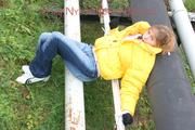 Leonie tied and gagged outdoor wearing a shiny yellow downjacket (Pics)