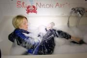 Watching Sonja taking a foam bath  wearing sexy blue shiny nylon rainwear (Pics)