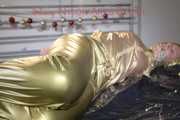 Pia tied, gagged and hooded on bed wearing a sexy golden rain combination and wings (Pics)