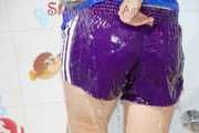Sonja taking a shower wearing a very hot purple shiny nylon shorts and a blue rain jacket (Pics)