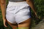 Watch Chloe enjoying her shiny nylon Shorts outside at a sunny Day