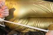 Pia tied, gagged and hooded on bed wearing a sexy golden rain combination and wings (Pics)