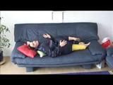 Jill lolling on a sofa wearing sexy shiny nylon rainwear (Video)