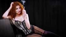 Alluring lady in sexy lingerie taking a whiff of a 120mm cigarette