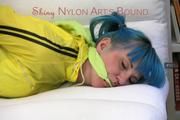 Mara tied and gagged on a white sofa wearing a sexy blue/yellow shorts and a yellow rain jacket (Pics)