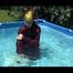 SEXY MARA wearing a special shiny down suit sun bathing and swimming in the pool (Video)