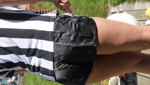 Watching Pia sweeping the terrace wearing a sexy black shiny nylon shorts, a striped top and black rubber boots (Pics)