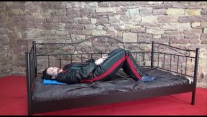 Jill ties and gagges herself sitting on a princess bed in an old cellar wearing sexy black shiny nylon down wear (Video)