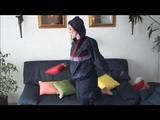 Jill lolling on a sofa wearing sexy shiny nylon rainwear (Video)