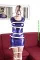 Sophie bound with Leatherbelts and Harnessgagged wearing a shiny purple Dress