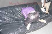 Sandra tied and gagged on a sofa with cuffs and a pillory wearing hot purple down jacket and black down pants (Pics)