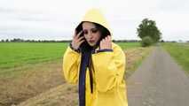 Miss Amira on the road in a Frisian mink, yellow rain dungarees and rubber boots