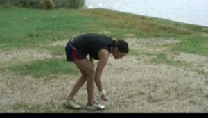 Enni wearing sexy shiny nylon shorts and top while throwing stones in a lake (Video)