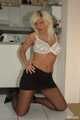 Blonde and busty business woman Martina stripping out of her white shirt, black skirt and pantyhose