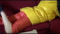 Watching sexy Lucy wearing a orange/yellow shiny nylon downwear combination reaing a magazine and lolling on the sofa (Video)