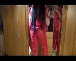 Lucy posing infront of the mirror wearing a supersexy red rainwear jumpsuit (Video)