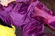 Lucy wearing a supersexy purple rain suit with hood while preparing her bed (Pics)