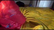 Jill tied, gagged and double-hooded on a bed wearing sexy shiny nylon rain pants and a down jacket (Video)