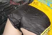 Lucy wearing a sexy black/yellow shiny nylon shorts and a yellow rain jacket preparing her sofa with a special cloth to enjoy it (Pics)