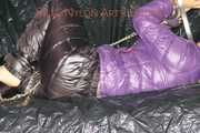 Sandra tied and gagged on a sofa with cuffs and a pillory wearing hot purple down jacket and black down pants (Pics)