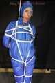 Watching sexy Pia being tied and gagged overhead with ropes and a ballgag wearing a supersexy blue shiny nylon bib overall and a rain jacket (Pics)