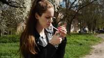Non smoker Masha is smoking two all white 120mm cigarettes outside