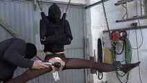 In straitjacket on chain hoist