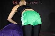 Watching sexy Sandra wearing a sexy black cycling shorts, a top and a sexy green shiny nylon shorts while preparing her bed (Pics)