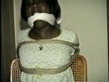 BLACK BANK TELLER IS MOUTH STUFFED, CLEAVE GAGGED & ROPE TIED TO CHAIR  (D46-2)