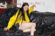 Lucy wearing a sexy black/yellow shiny nylon shorts and a yellow rain jacket preparing her sofa with a special cloth to enjoy it (Pics)