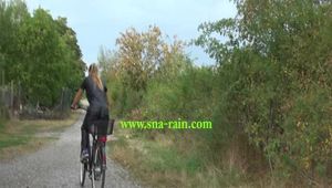 Watch Sandra riding her bike enjoying her shiny nylon Jumpsuit