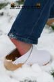 Linda with white clogs in the snow