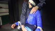 Watching Aiyana wearing sexy shiny nylon rainwear being stuffed, tied and double hooded of a dom (Video)