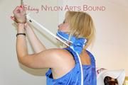 Pia wearing a super sexy lightblue shiny nylon bib overall tied and gagged on a stairway over her head (Pics)