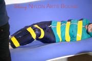 Mara tied and gagged with tape on a sofa wearing a supersexy shiny blue rain pants and a grren rain jacket (Pics) 