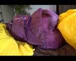 Lucy wearing a purple rain suit preparing her bed cloths for enjoying herself and the rain suit in bed lolling around (Video)