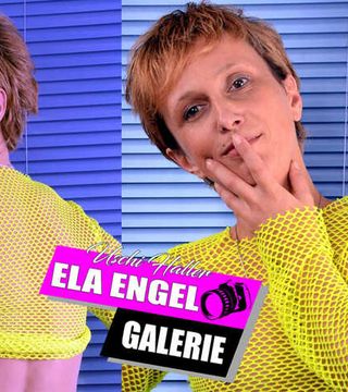 Ela Engel in the studio with yellow fishnet shirt