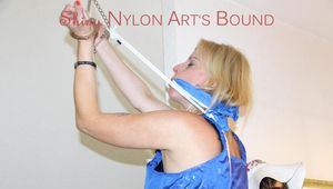 Pia wearing a super sexy lightblue shiny nylon bib overall tied and gagged on a stairway over her head (Pics)