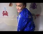 Jill posing and playing with water and foam in the bath tub wearing a sexy lightblue shiny nylon shorts and an oldschool blue rain jacket (Video)