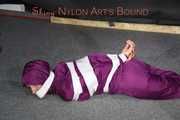 Sexy Sandra being tied, gagged and hooded with tape on the floor wearing a supersexy purple rain overall (Pics)