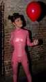 A babypink latex catsuit with Emma and a wet diaper inside
