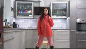 Miss Amira in red nylon rain gear and tranparent rain suit get´s bouind and gagged