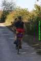 Watch Sandra riding her bike enjoying her red shiny nylon Shorts