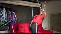 Sonja tied with ropes overhead and gagged wearing a sexy black rain pants and a special red rain jacket (Video)