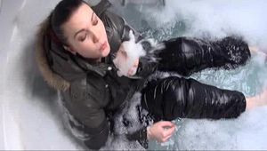 Jill Diamond wearing a supersexy black rain pants and a darkgreen down jacket in the bathtub (Video)