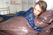 Stella wearing a supersexy blue shiny nylon rainwear while lolling in bed (Pics)