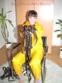 Jill tied, gagged and hooded with a tension belt on a chair wearing a supersexy yellow shiny nylon rainpants and rain jacket (Pics)