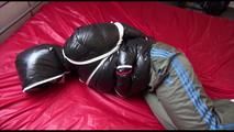 Jill tied, gagged and hooded on bed wearing a sexy shiny black downjacket with a closed hood (Video)