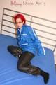 Marlin posing on a bed wearing a sexy black shiny nylon venice beach and a blue rain jacket (Pics)